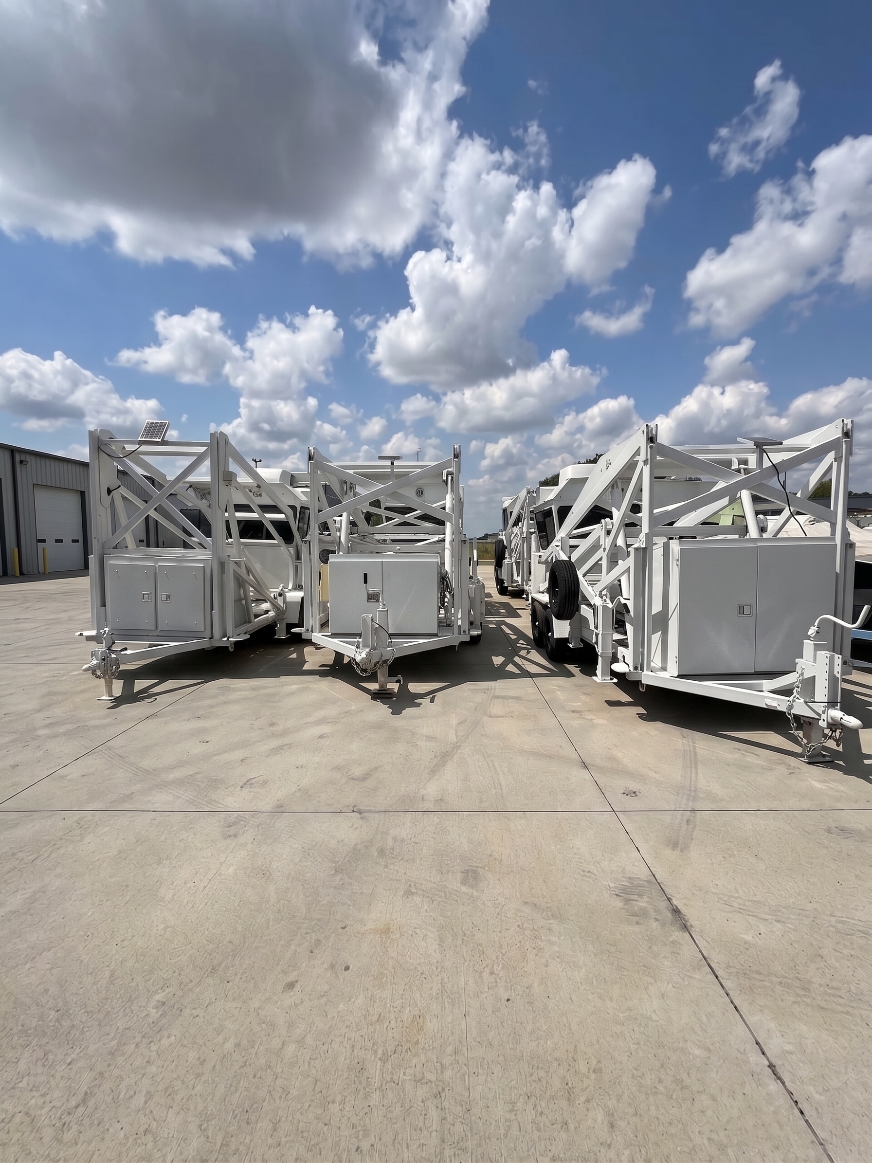 Multiple folded surveillance tower trailers staged for deployment