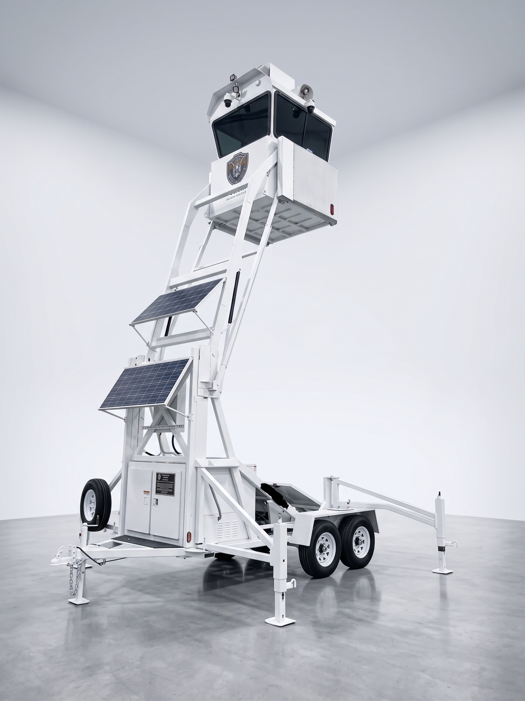 White autonomous surveillance tower fully extended on a towable trailer
