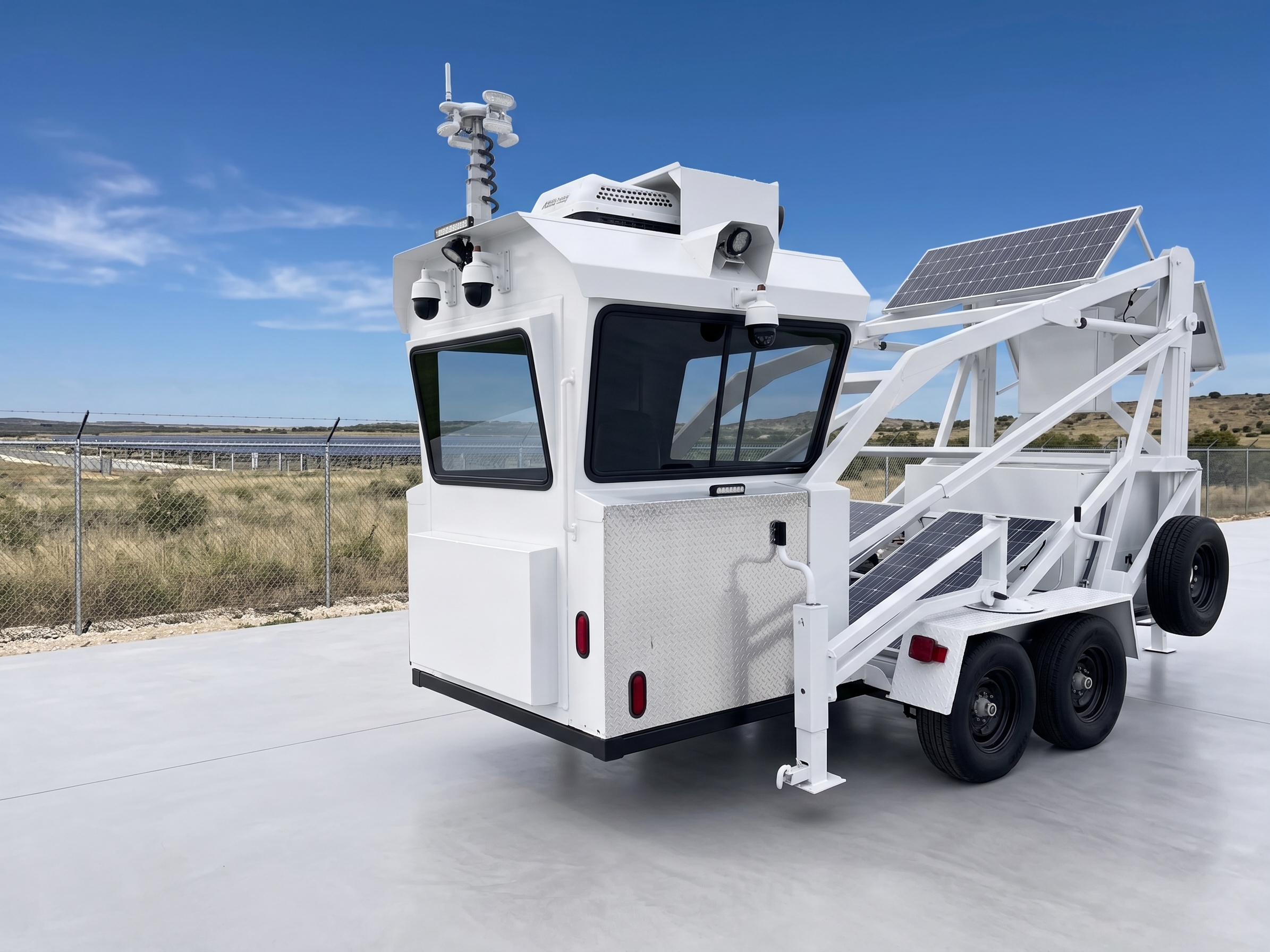 Solar-powered mobile surveillance unit deployed beside a secured utility site
